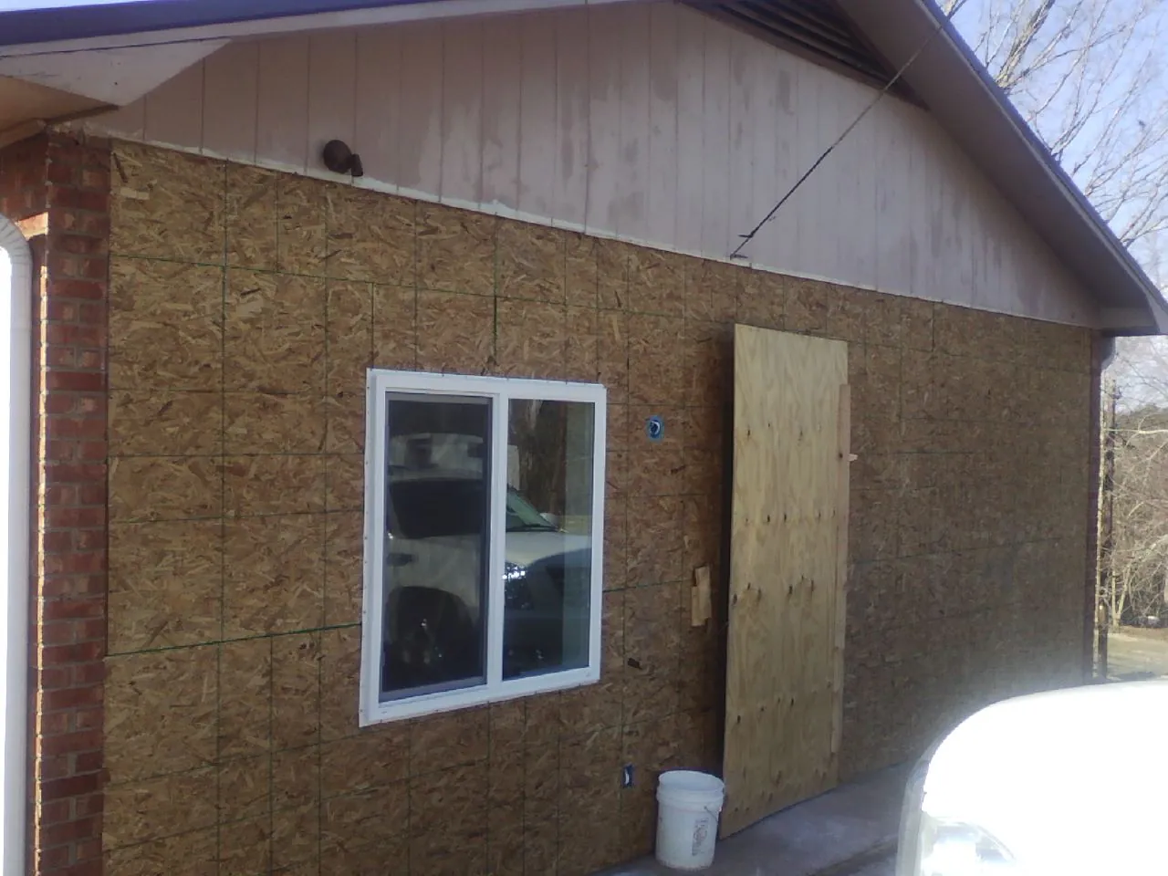 OSB sheathing on a garage addition wall before siding in Shipman